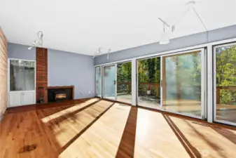 Open floor plan with lots of windows and wood burning insert