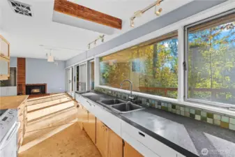 Kitchen with concrete and butcherblock countertops overlook the large deck