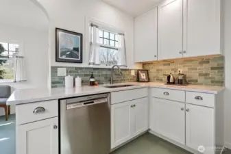 the window over the sink looks over the side yard patio . . .