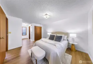 Full primary suite with attached bathroom and several closets.
