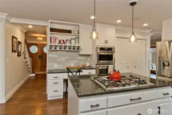 Kitchen layout with island, stainless appliances, and workspace.
