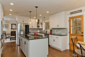Kitchen with quartz countertops, stainless steel appliances, and center island.