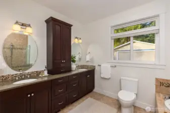 The spa-like bath includes a generous soaking tub, a double vanity, a spacious walk-in shower and heated floors.
