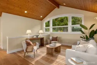 Nestled between the two upper level bedrooms is the sunny loft with vaulted ceilings.