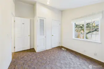 Hot water heater is behind the smaller closet door.