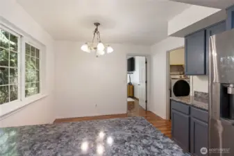 Kitchen with a spot for a kitchen table that leads to the family room