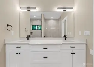 Gorgeous double vanity in the primary bath that shows the tiled shower and separate bath tub