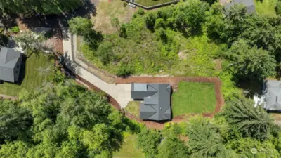 Sky view of the long, private drive leading to the custom built home of your dreams