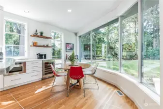 Large eat-in kitchen area with a park like view with large picture windows