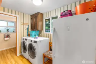 Laundry room is right off the family room. Powder room/half bath is in the background.