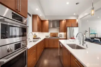 A separate wall oven & microwave with a gas cooktop in the foreground.