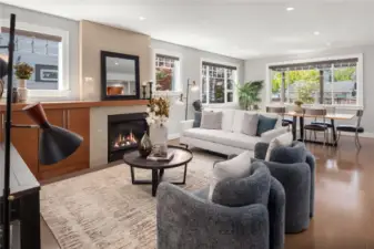 A gas fireplace with built-in cabinet and wood mantle provides an added warmth to the forced air heating.