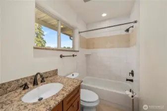 Full bathroom located on the upper level in the bonus room -