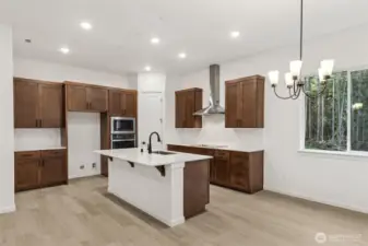 ***Actual Home *** Kitchen dining area with Ginger stained cabinets and bronze fixtures