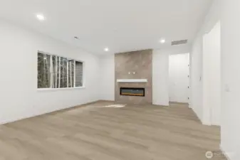 ***Actual Home *** Great Room with tiled fireplace a views to the back and green space