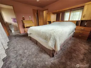 Primary bedroom connected to private bathroom and walkin closet