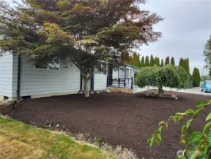 Landscaped front of home & deck entry viewed from back yard