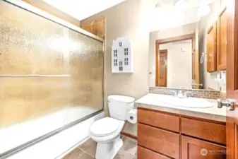 The main bathroom is located off the hallway of the two additional bedrooms.