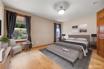 The inviting primary bedroom features an adjoining en suite bathroom and spacious walk-in closet.