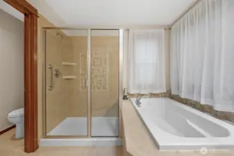 The primary bath features a luxurious soaking tub, and dual sinks and separate shower..