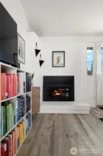 Original brick fireplace has been modernized with a newer gas insert.