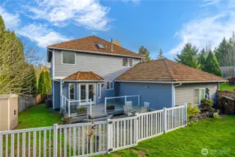 Trex deck steps down to a gated paver patio, thoughtfully separated from the koi pond and garden oasis.