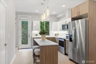 Stainless Steel appliances, kitchen with island seating make this area so inviting.
