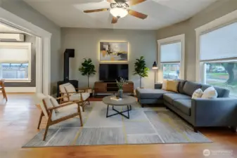 A daylit front living room to enjoy sunsets and the warm fireplace. *virtually staged