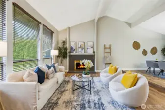 Vaulted ceilings and abundant natural light greet you in the formal living room with cozy fireplace.