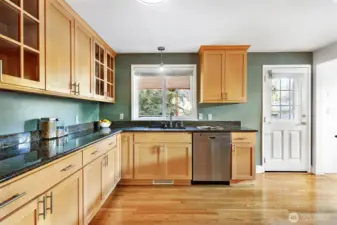 Lovely honey-toned cabinetry complements the hardwood flooring.