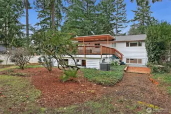 Looking toward the back patio with stairs leading up to the covered deck.