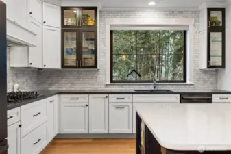 Chef’s kitchen with high end appliances and custom cabinetry.