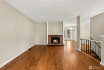 Same room - showing the wood-burning fireplace and dining area beyond.
