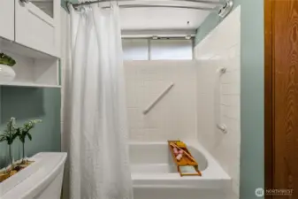 Closer view of the shower surround and tub.