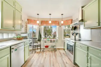 The refreshed kitchen opens to a cheerful breakfast nook wrapped in windows—an inviting place to ease into your morning. Updated Luxury Vinyl Plank (LVP) flooring (2022) and modern finishes complete the space.