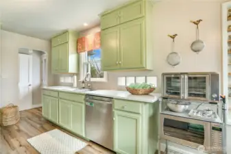 A window over the sink brings in natural light, while an updated dishwasher (2020) and ample cabinetry support easy daily routines.