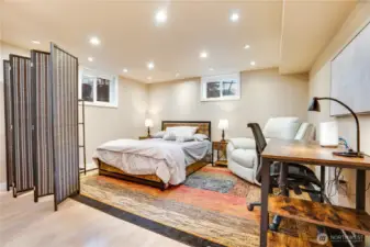 Recessed lighting and windows keep this space bright—ready to function as a sleeping area, workspace, or a private retreat.