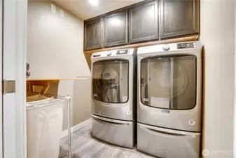 This dedicated utility room includes a second laundry area with commercial-grade Maytag appliances and overhead storage, adding everyday practicality and convenience.