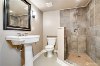 A clean, modern three-quarter bath with a walk-in shower offers comfort and convenience for longer stays or separate living.