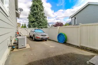 Fenced RV parking on side of home.