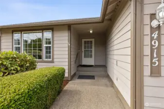 The covered front entry of this home offers side space for a seat or holiday décor and comes with a storm screen door too!