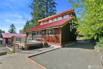 The side of the home has a terrific paver patio set up in front of what the current owners use as a regulation P'etanque court! Lots of out of the way outdoor storage.