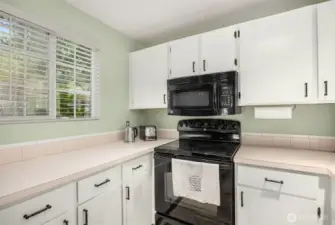 Bright lighting overhead makes every task easier, from chopping vegetables to reading recipes and managing dinner prep.