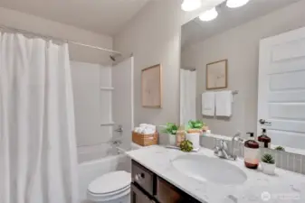 A divine full bath services bedrooms two and three.