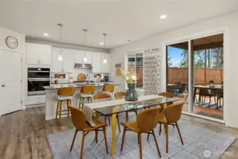 The home features an open concept kitchen, dining and living room for easy flow . This dining space looks out towards the back yard.
