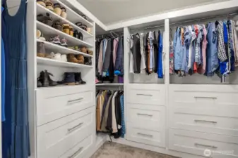 Owner installed this fantastic walk in closet with lots of hanging space and drawers.