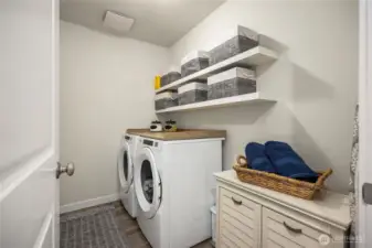 Upstairs laundry room is a MUST when you have the bedrooms upstairs. Plumbed for a sink where the little storage chest is.