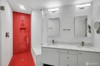 Looking into the primary bath. Double sinks and roomy modern shower. Love the color