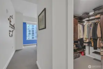 From the hall looking into the primary bedroom to see the walk in closet. The organizers really make it efficient!