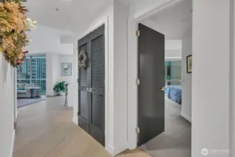 From the Bedroom to the living room. Washer Dryer behind those double doors.